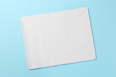 Photo of One mouse pad on light blue background, top view