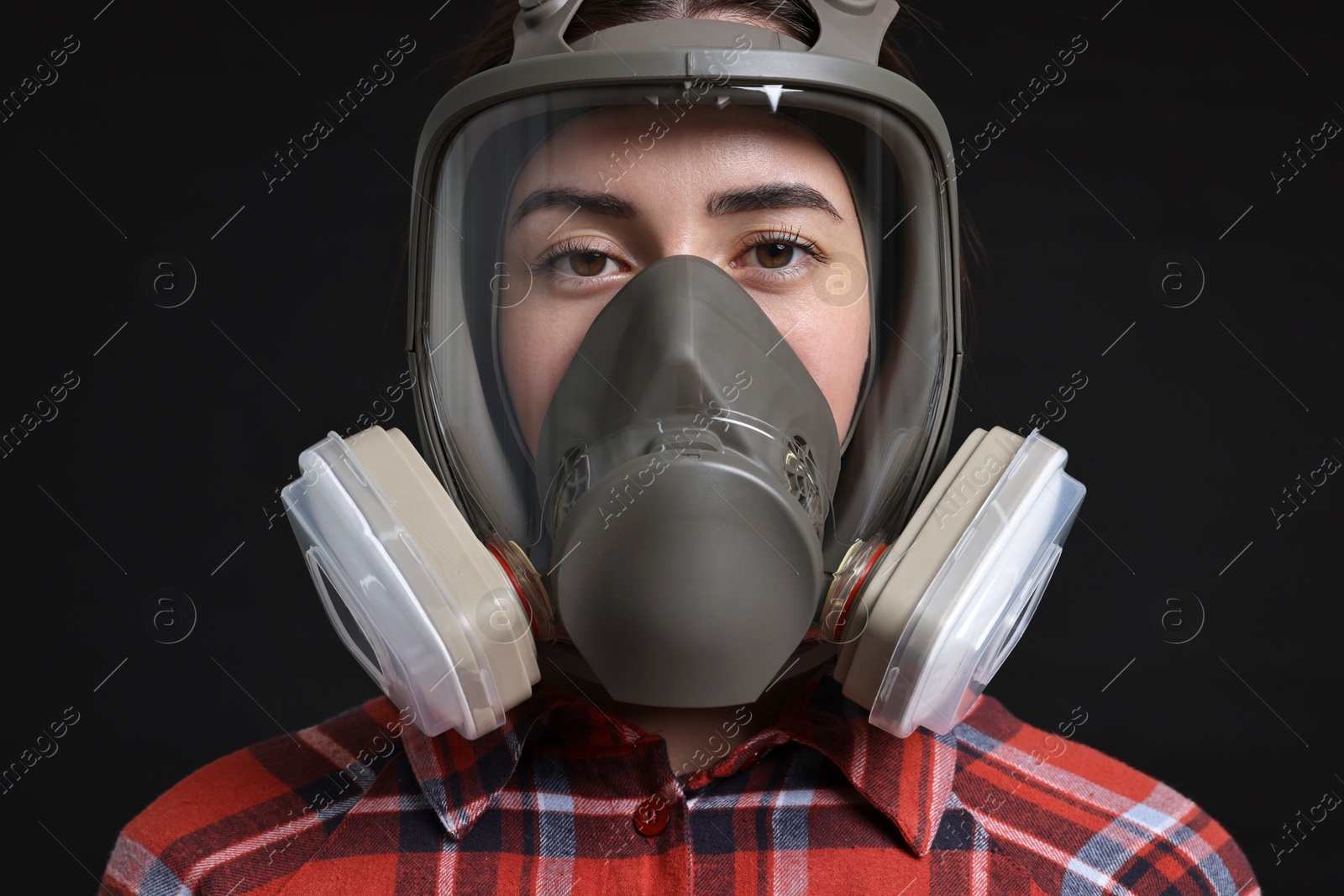 Photo of Woman in respirator mask on black background