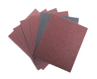 Photo of Sheets of sandpaper isolated on white, top view