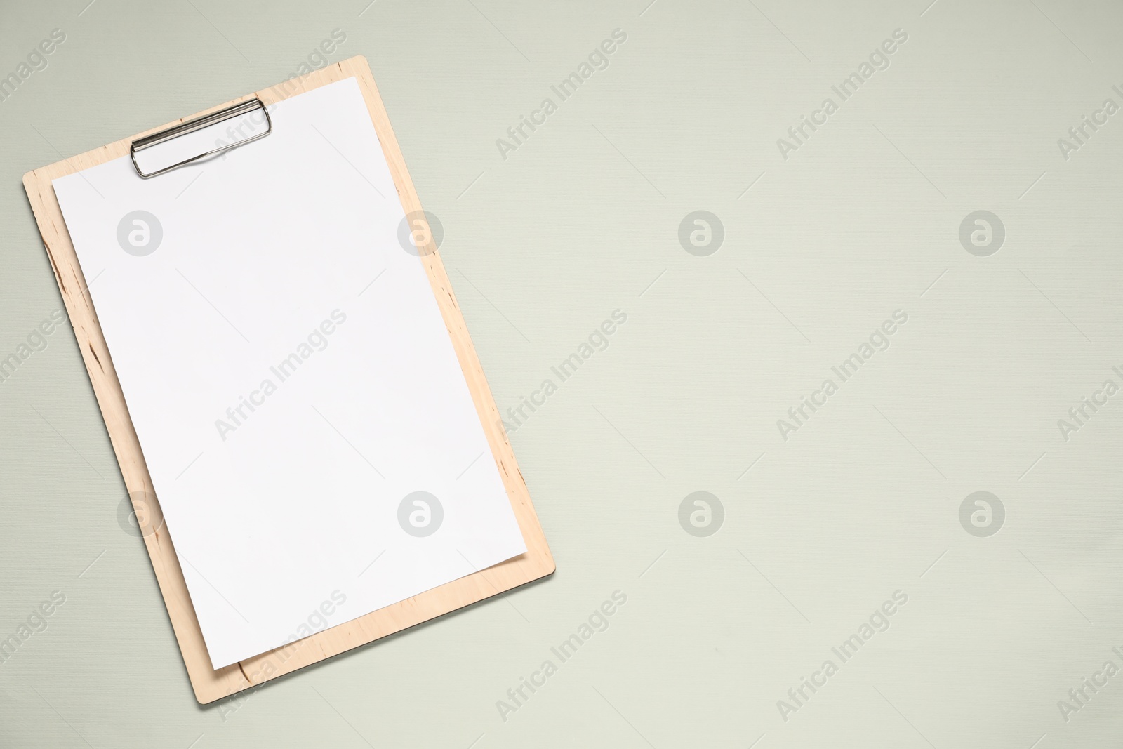 Photo of Clipboard with empty paper on light grey background, top view. Mockup for design