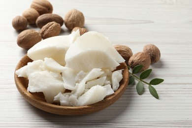 Natural shea butter, nuts and green leaf on wooden table