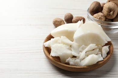 Natural shea butter and nuts on wooden table, space for text