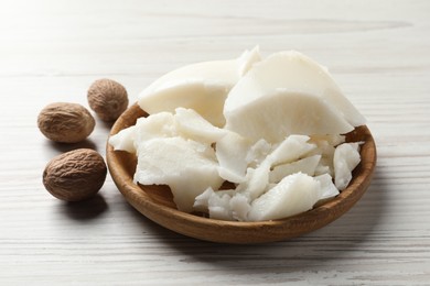 Photo of Natural shea butter and nuts on wooden table