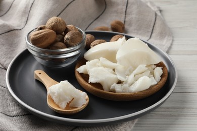 Photo of Natural shea butter and nuts on wooden table