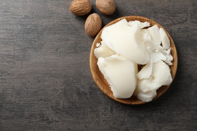 Natural shea butter and nuts on grey table, top view. Space for text