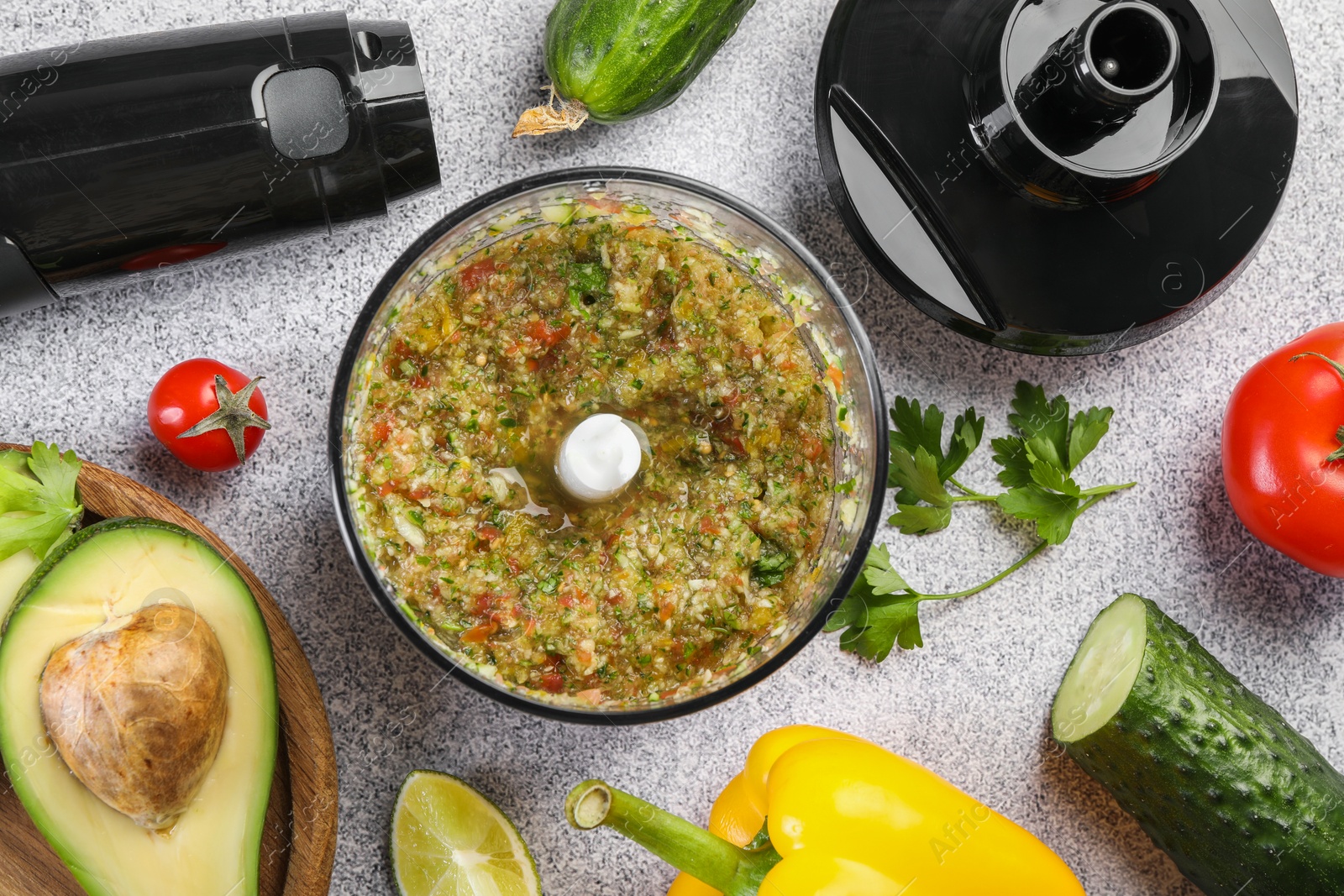 Photo of Hand blender kit, mixture of ingredients and fresh products on light grey table, flat lay