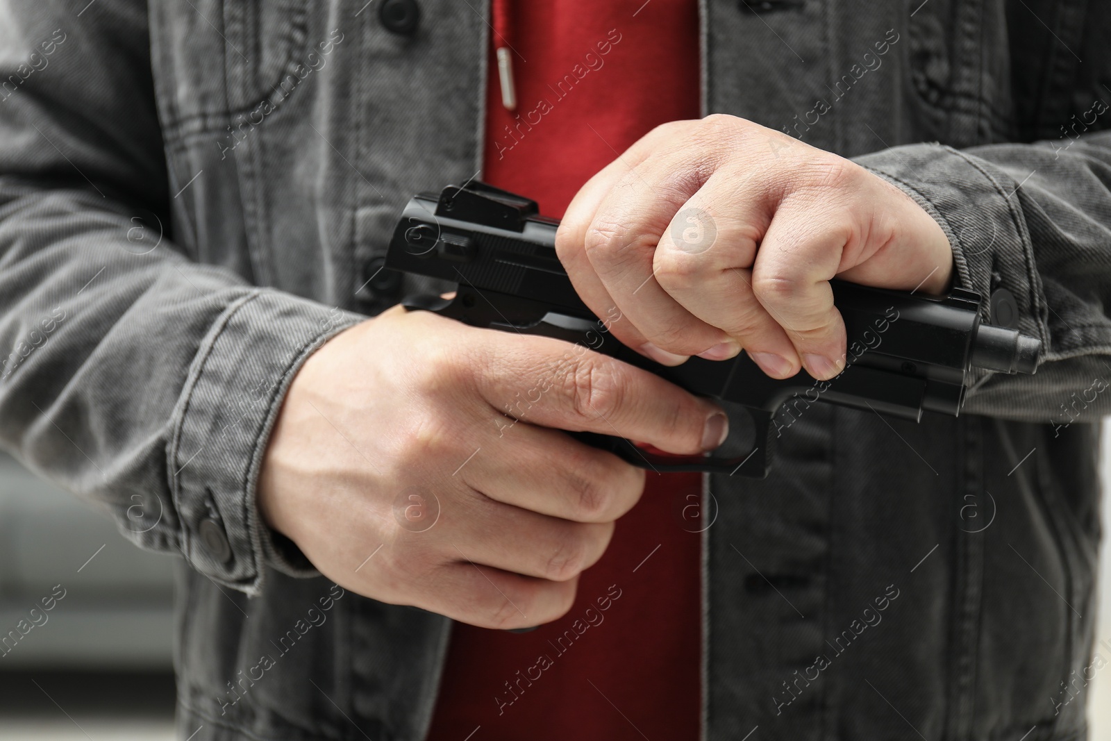 Photo of Dangerous criminal with gun in foreign house, closeup. Armed robbery