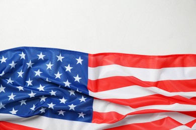 Photo of Flag of USA on white table, top view. Space for text