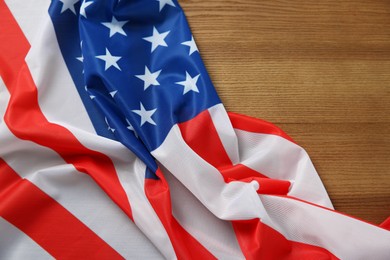 Photo of Flag of USA on wooden table, top view. Space for text