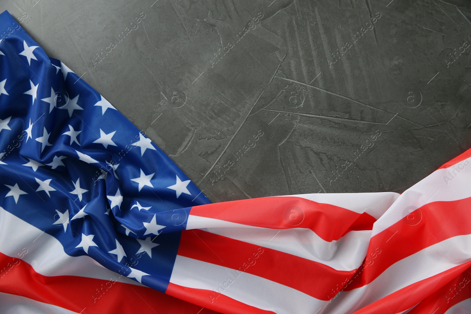 Photo of Flag of USA on black table, top view. Space for text