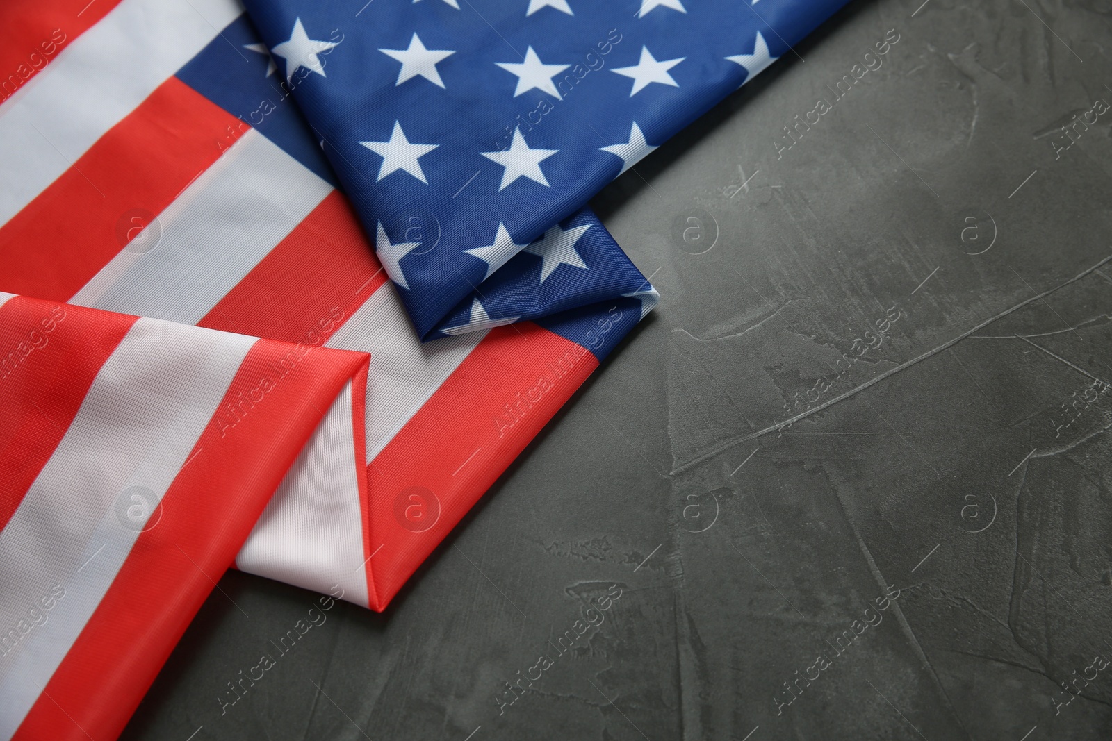 Photo of Flag of USA on black table, top view. Space for text