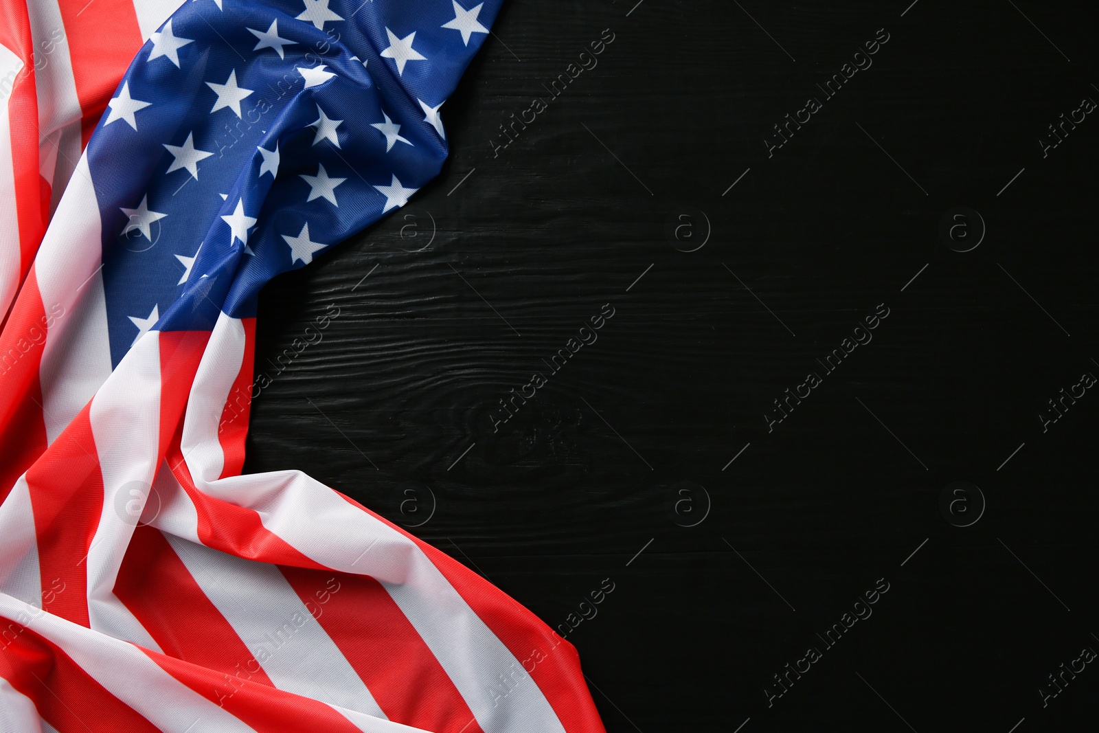 Photo of Flag of USA on black wooden table, top view