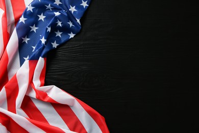 Flag of USA on black wooden table, top view