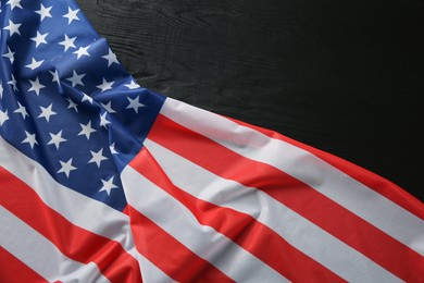 Photo of Flag of USA on black wooden table, top view