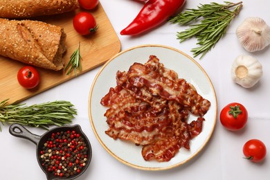 Photo of Slices of tasty fried bacon, tomatoes, different spices and bread on white table, flat lay