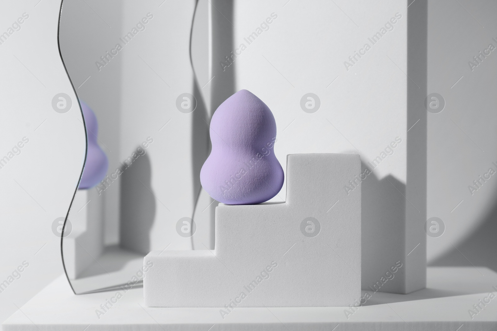 Photo of Stylish presentation of makeup sponge on light grey background