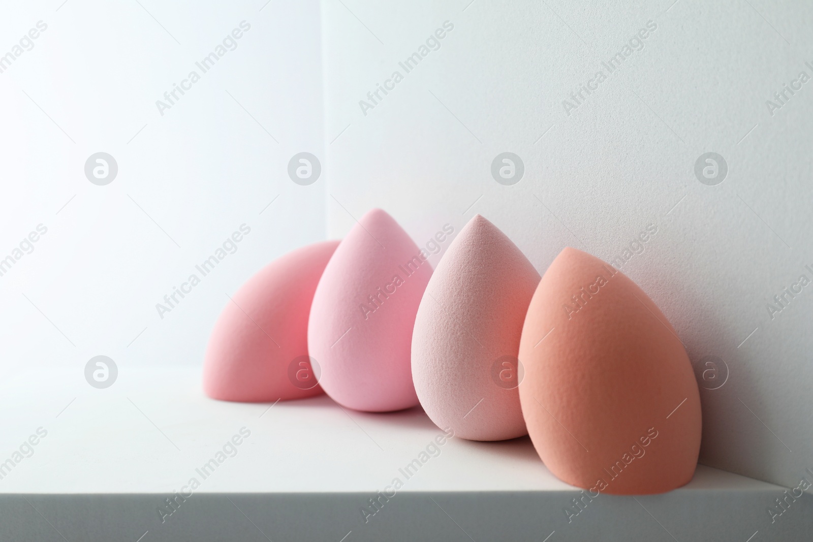 Photo of Stylish presentation of makeup sponges on light grey background