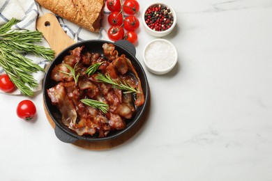 Photo of Delicious bacon slices in frying pan, spices and tomatoes on white table, flat lay. Space for text