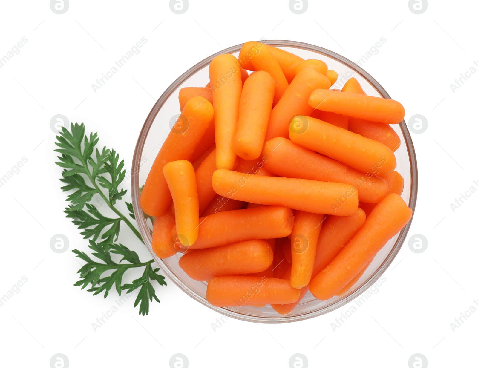 Photo of Baby carrots in bowl and green leaf isolated on white, top view