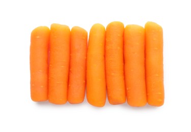 Photo of Many baby carrots isolated on white, top view