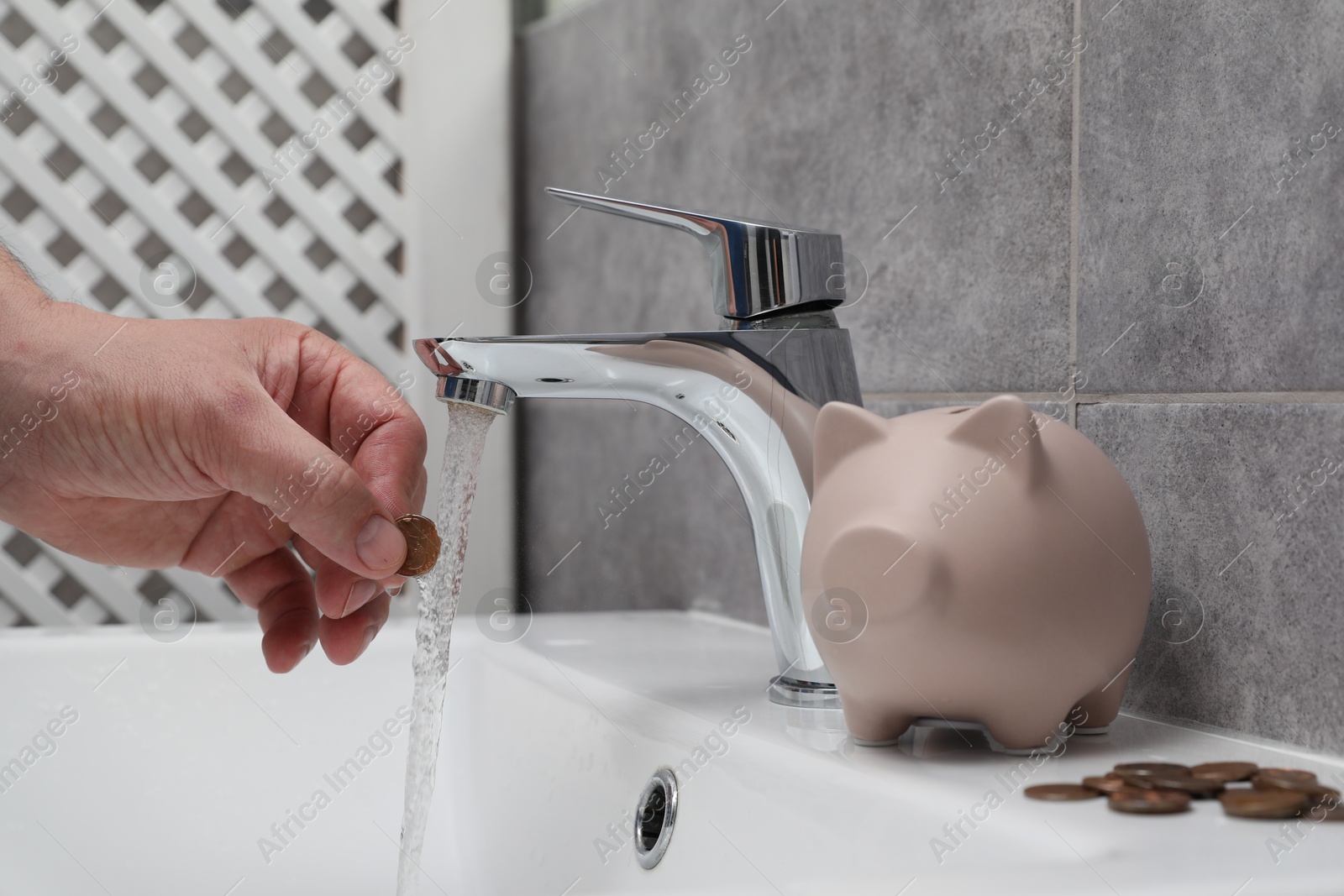 Photo of Water saving concept. Woman with coin under tap water in bathroom