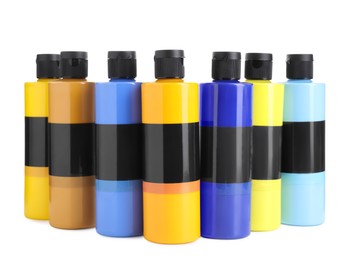 Photo of Acrylic paints of different colors in bottles isolated on white