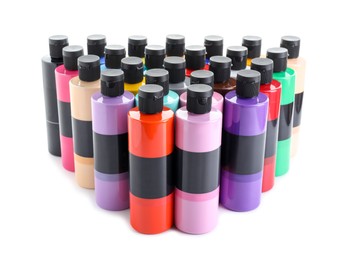 Photo of Acrylic paints of different colors in bottles isolated on white