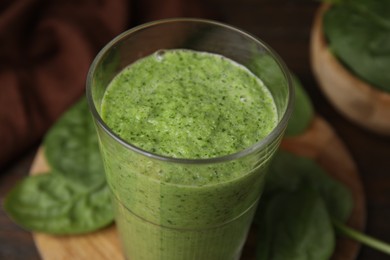 Photo of Tasty green smoothie in glass on table, closeup