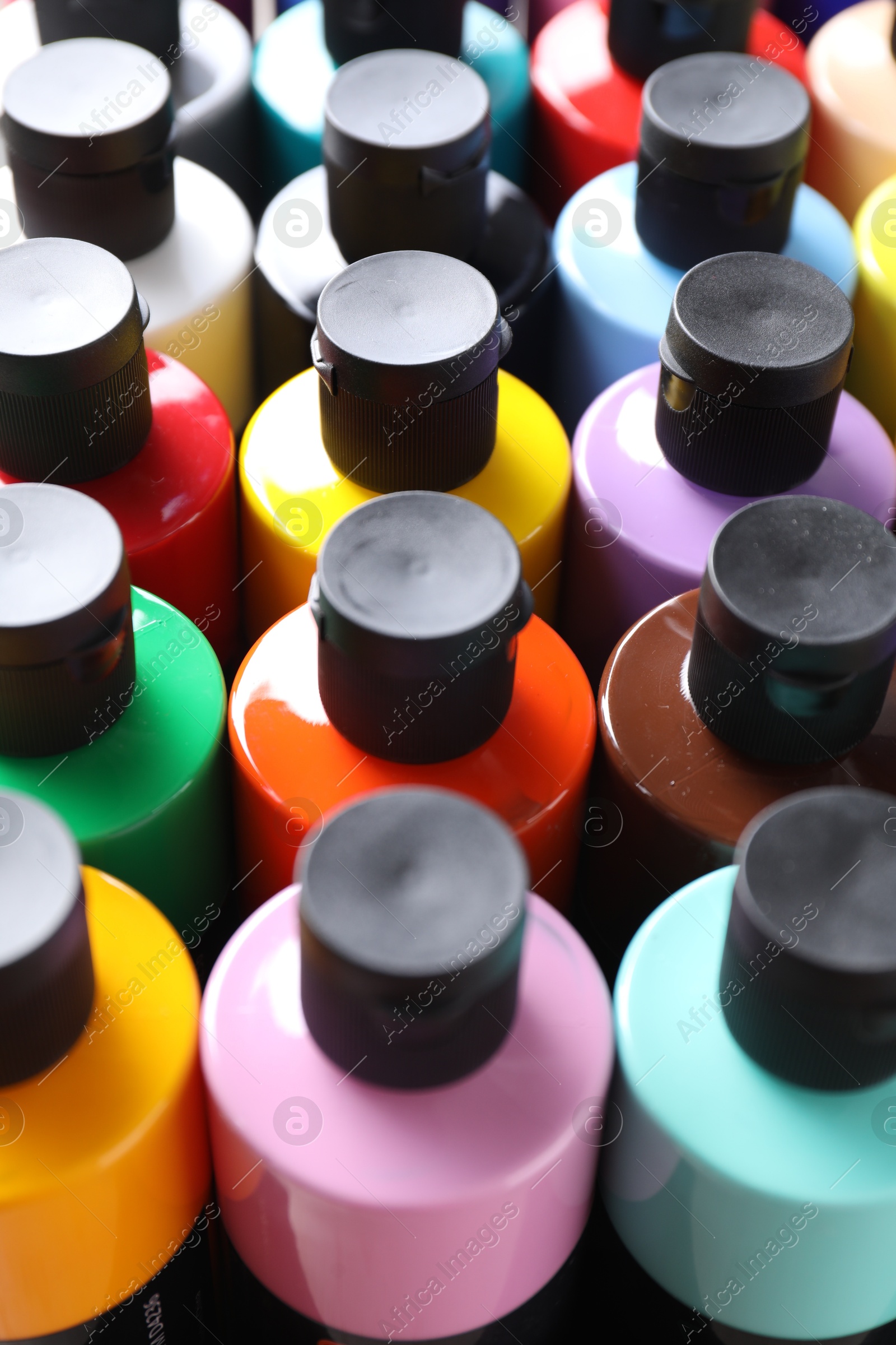 Photo of Acrylic paints of different colors in bottles, closeup