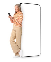 Happy mature woman holding mobile phone near big smartphone on white background