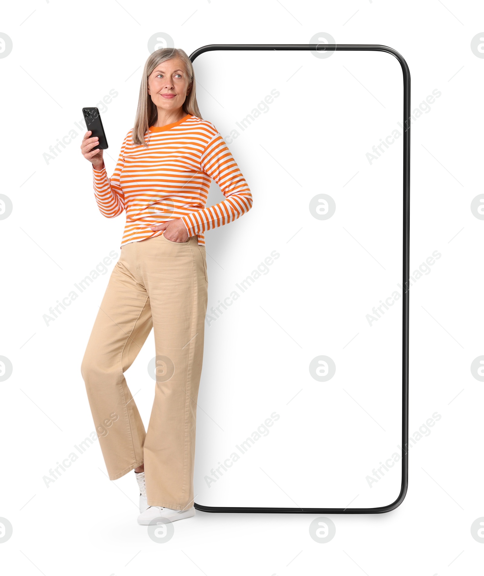 Image of Happy mature woman holding mobile phone near big smartphone on white background