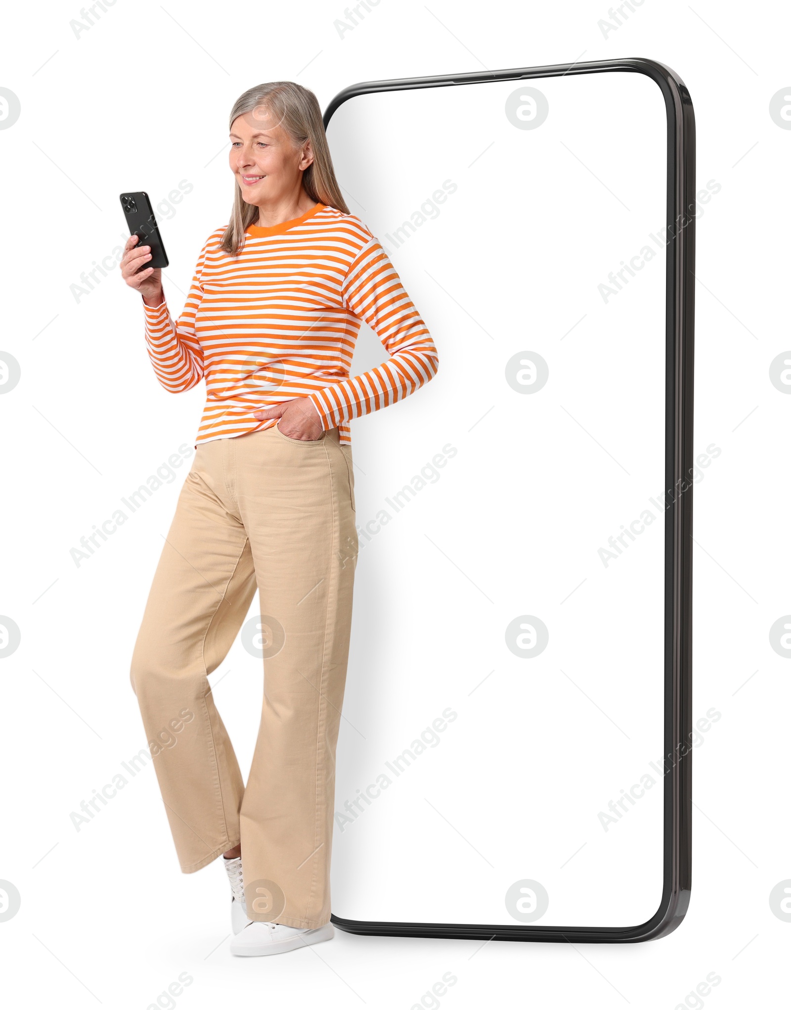 Image of Happy mature woman holding mobile phone near big smartphone on white background