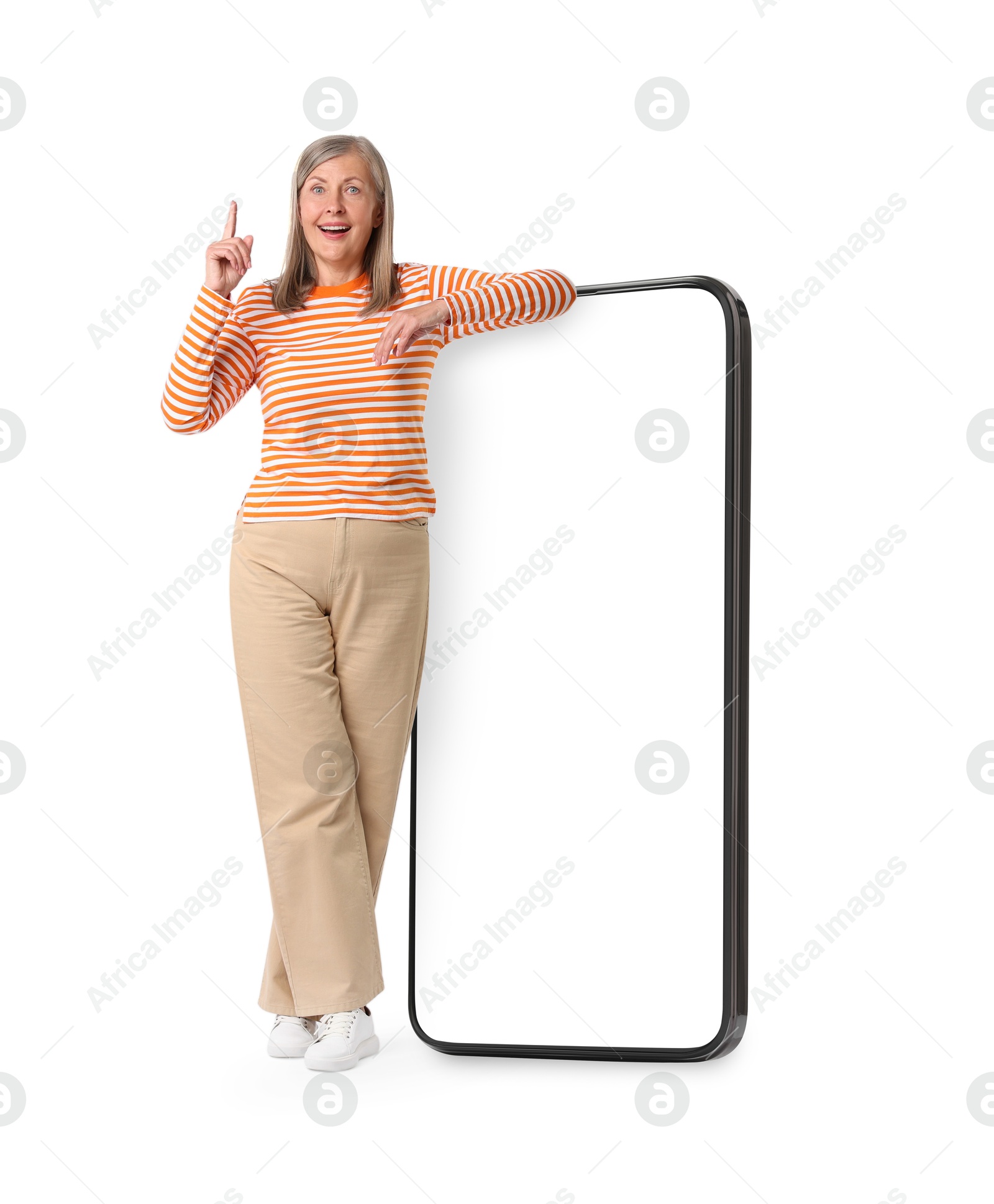 Image of Happy mature woman leaning on big mobile phone against white background