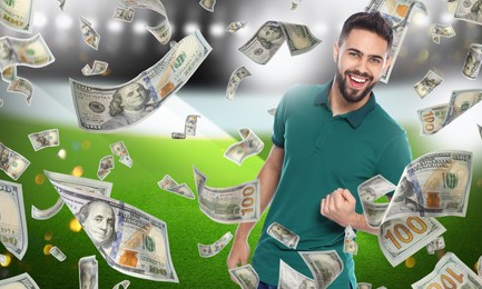 Image of Happy man under money shower at stadium