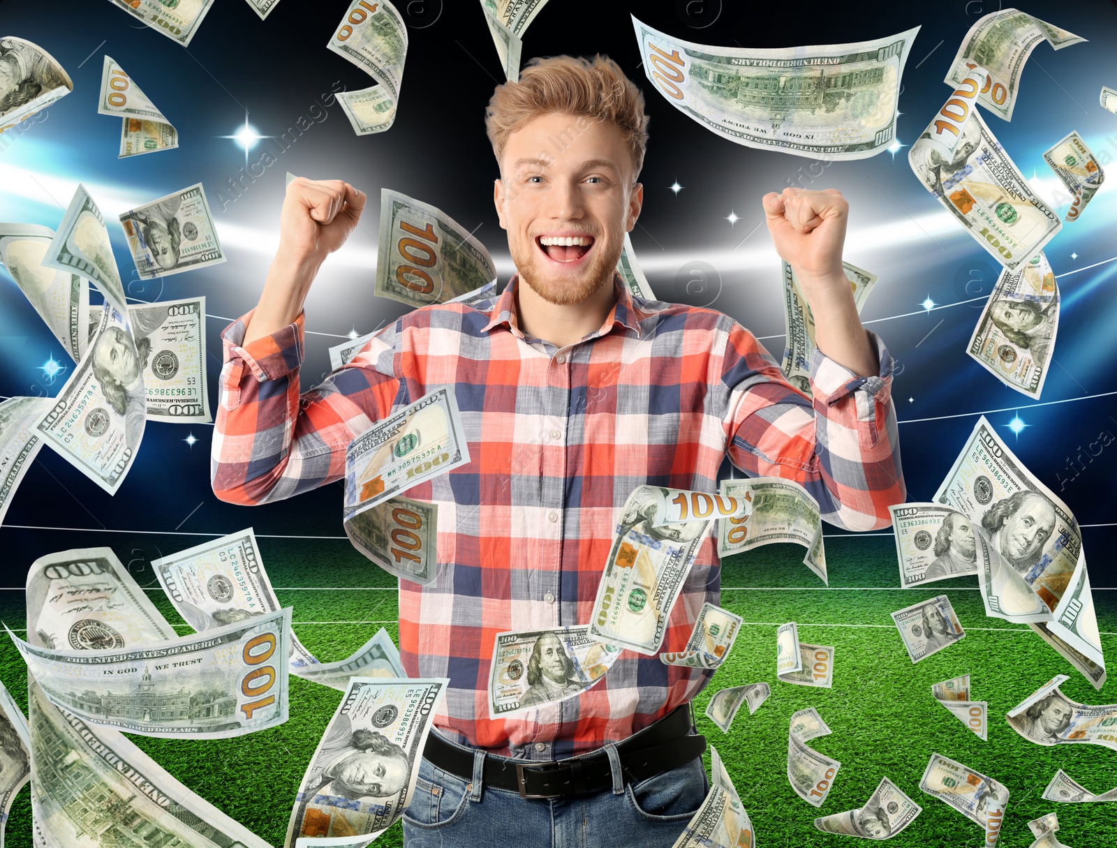 Image of Happy man under money shower at stadium