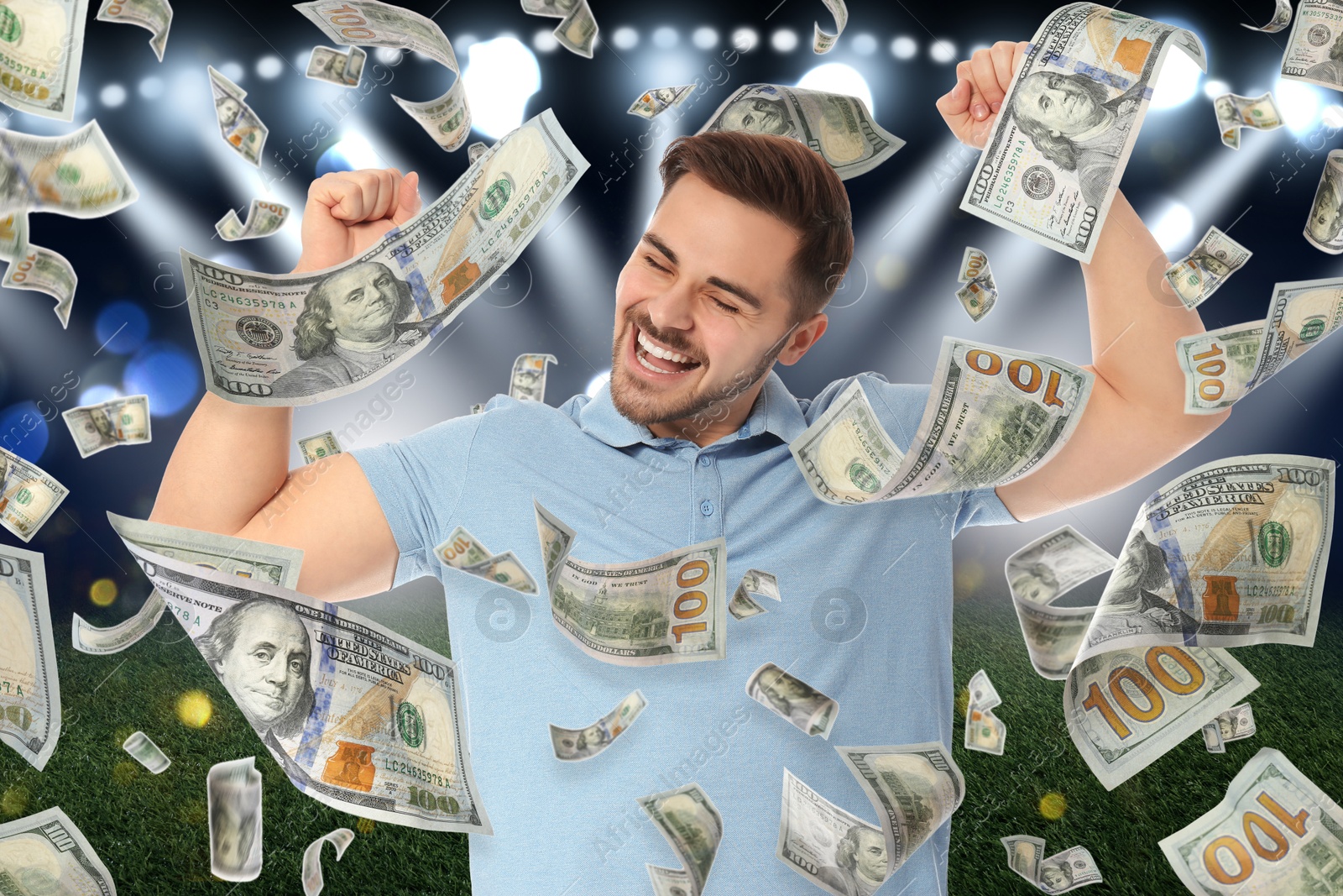 Image of Happy man under money shower at stadium