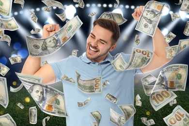 Happy man under money shower at stadium