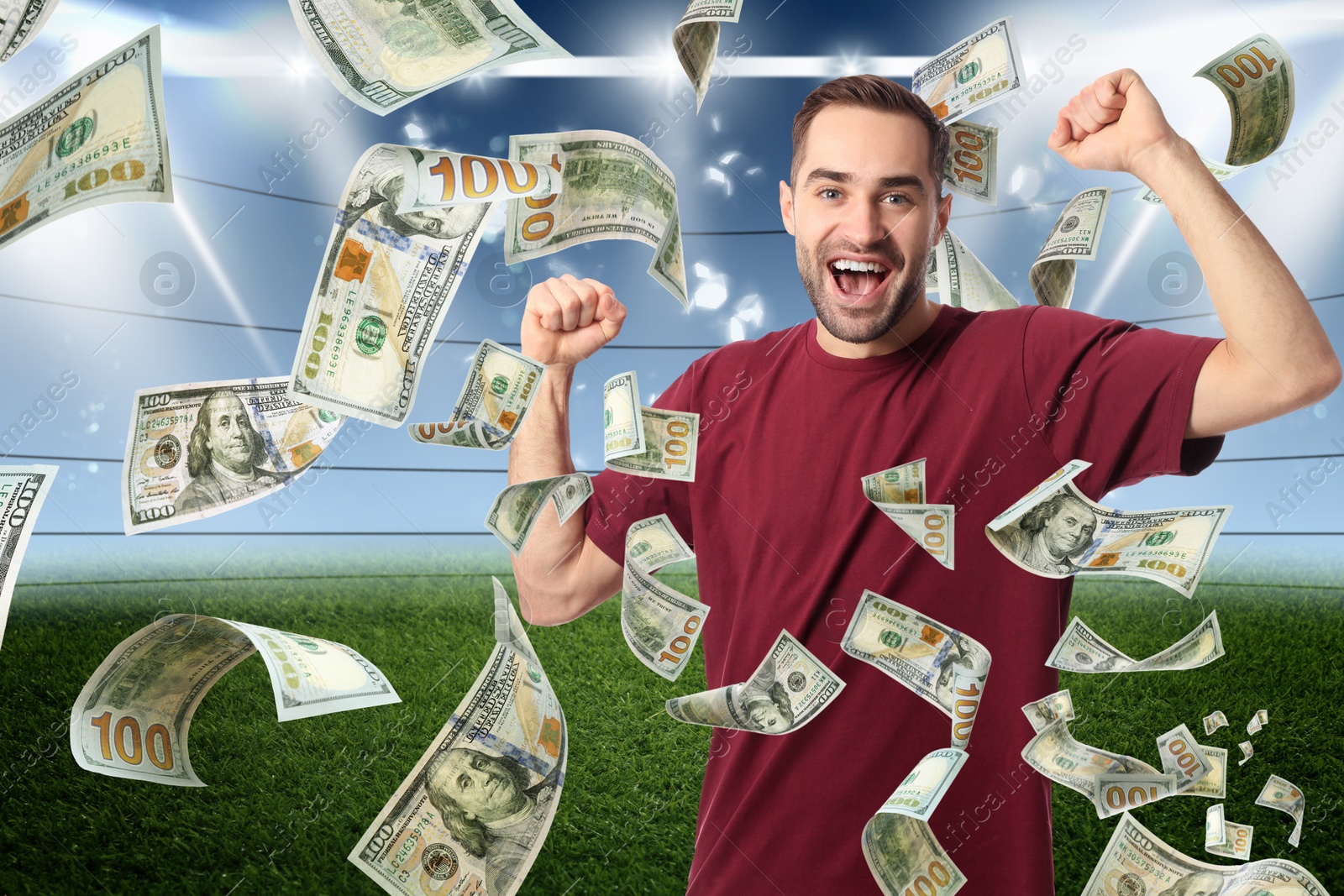 Image of Happy man under money shower at stadium