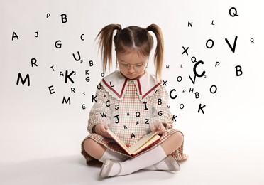 Image of Girl with glasses reading book on white background. Letters flying out of book