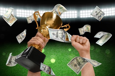 Image of Man holding gold trophy cup in money rain at stadium, closeup