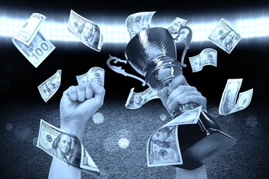 Image of Man holding gold trophy cup in money rain at stadium, closeup. Color toned