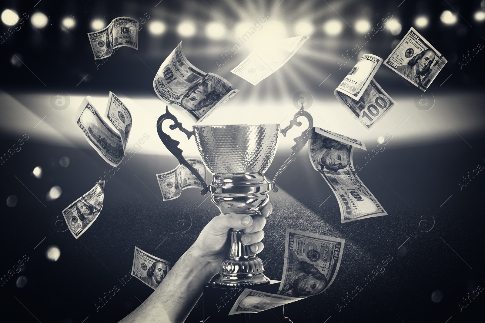 Image of Man holding trophy cup in money rain at stadium, closeup. Color toned