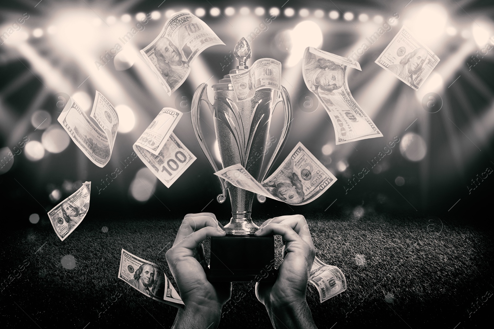 Image of Man holding gold trophy cup in money rain at stadium, closeup. Color toned