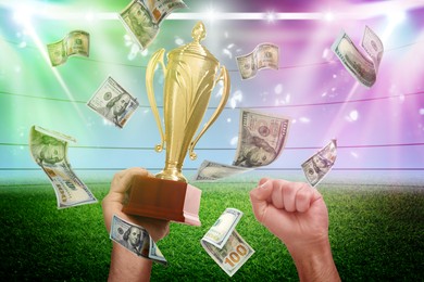 Image of Man holding gold trophy cup in money rain at stadium, closeup