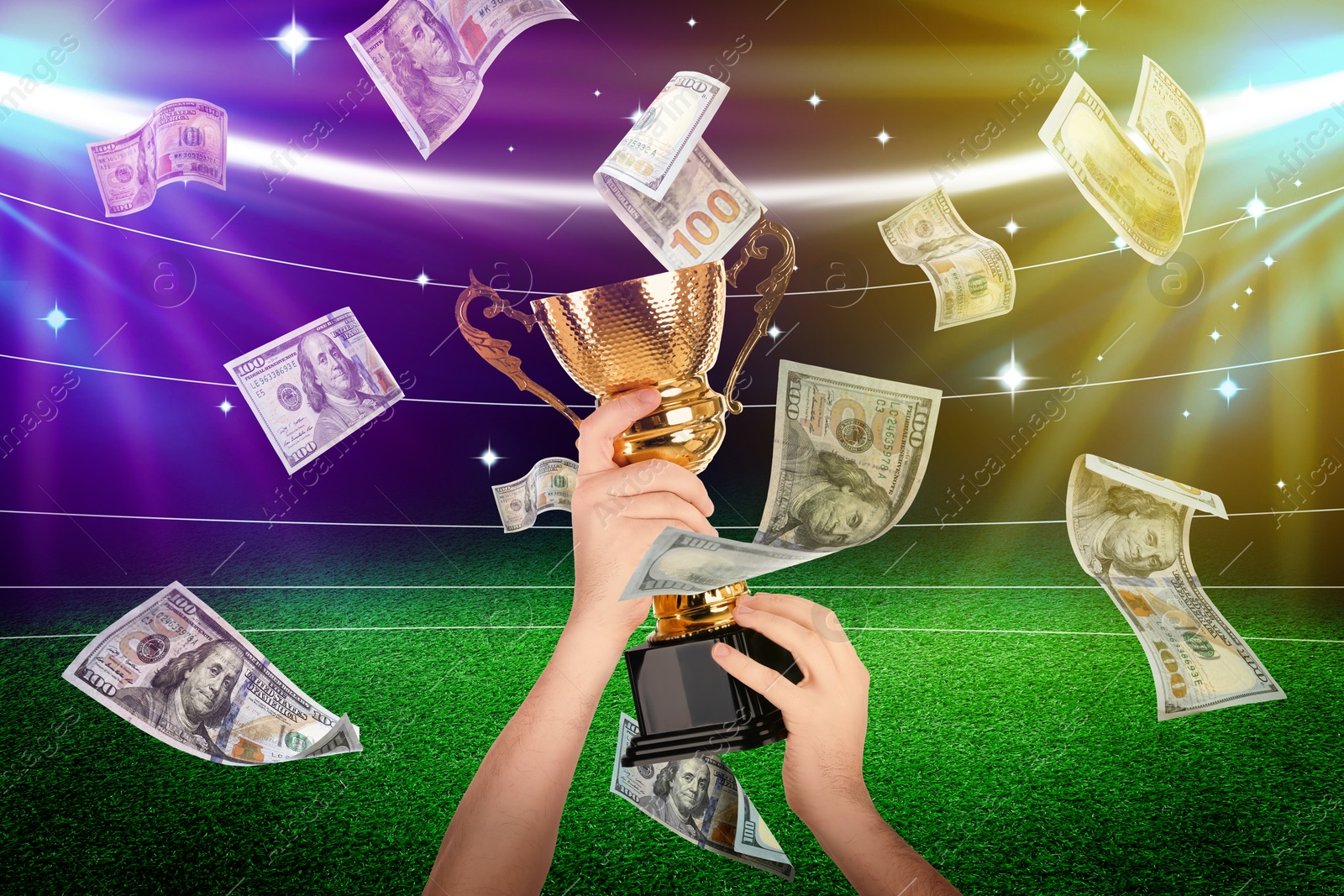 Image of Man holding gold trophy cup in money rain at stadium, closeup