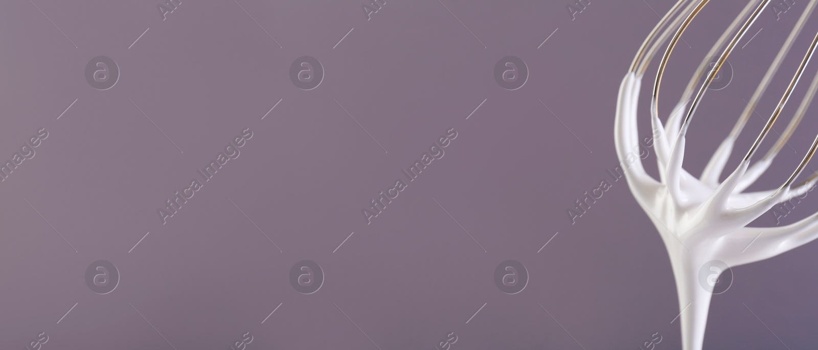 Image of Whisk with beaten cream on dark lavender background, closeup. Banner design, space for text