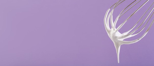 Image of Whisk with beaten cream on dark lavender background, closeup. Banner design, space for text