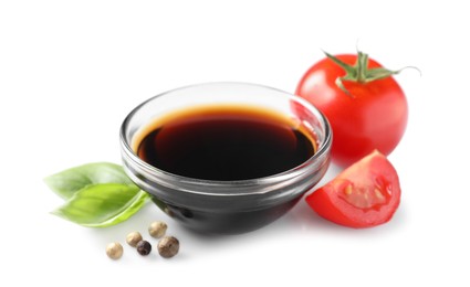 Delicious balsamic vinegar, basil, tomatoes and peppercorns isolated on white