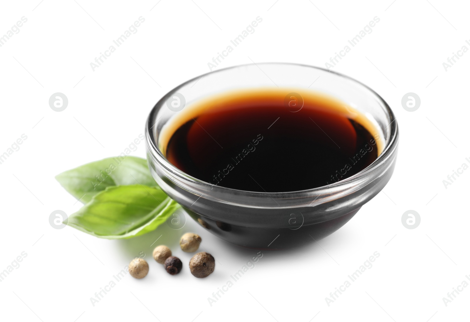 Photo of Delicious balsamic vinegar, basil and peppercorns isolated on white