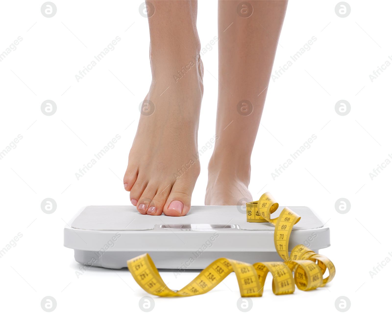 Photo of Diet and weight loss concept. Woman on floor scale and measuring tape against white background, closeup